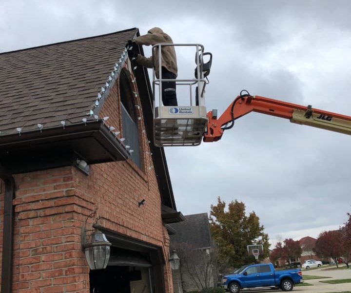 J & J Landscaping, LLC employees installing Christmas lights / décor at a home in Metro Detroit, Michigan