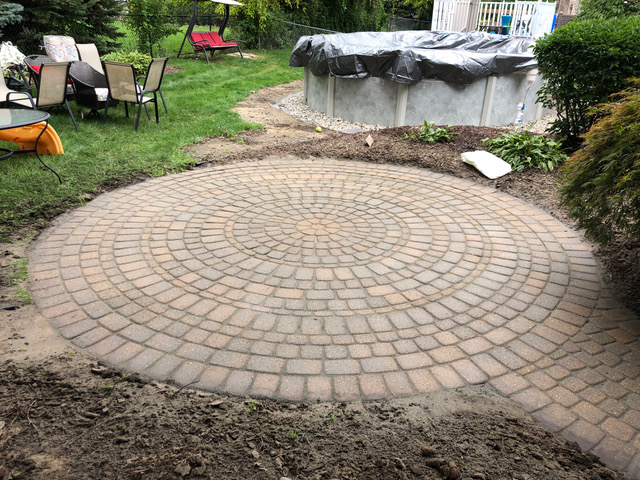 Pavers power washed and sanded with high quality polymer sand to keep out weeds and prevent shifting in Macomb, MI by J & J Landscaping, LLC