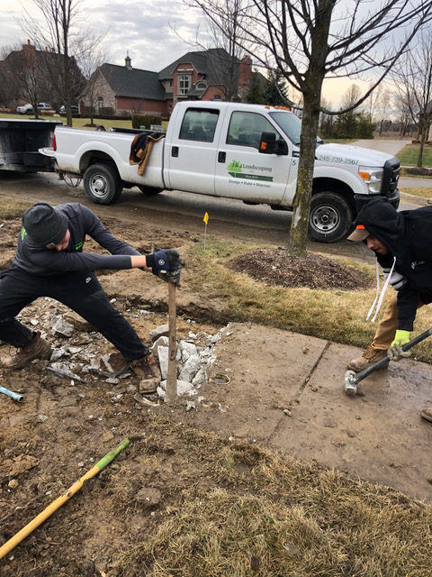 J & J Landscaping, LLC employees performing concrete removal in Metro Detroit, Michigan