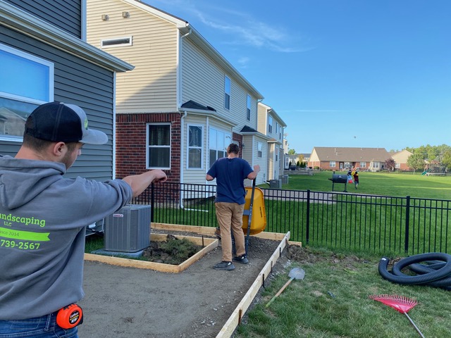 Image of the J & J Landscaping, LLC team installing a new concrete patio in Metro Detroit, Michigan