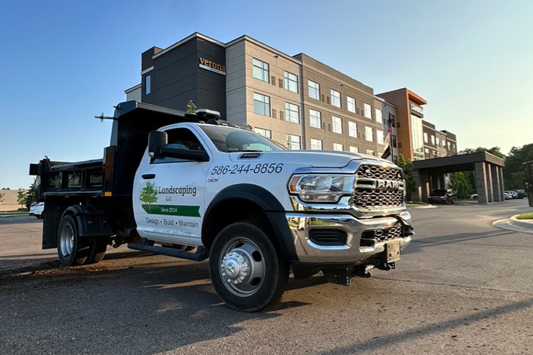 A J & J Landscaping work truck parked in front of a commercial property in Metro Detroit, ready to perform landscaping and grounds maintenance services