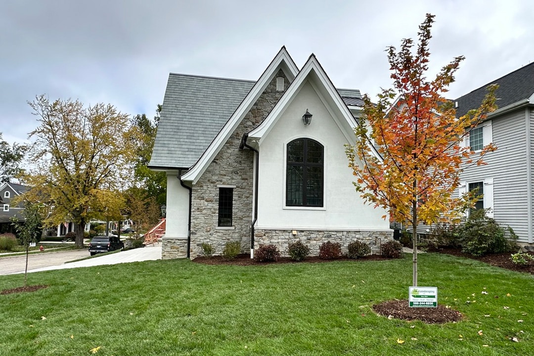 A well-manicured residential property after fall maintenance and leaf raking services by J & J Landscaping