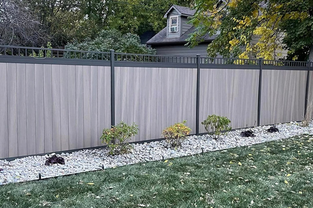 A vinyl privacy fence designed and built by J & J Landscaping for a residential property in Metro Detroit