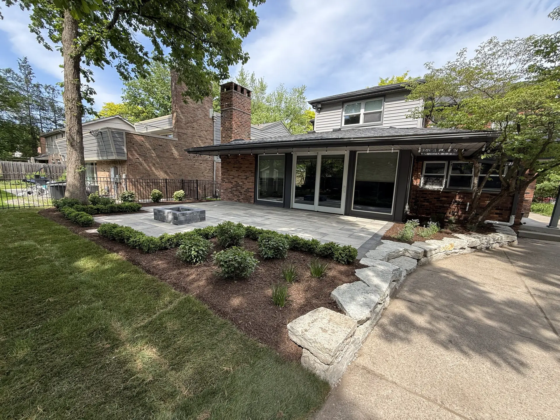 A residential landscape and patio installation designed by J & J Landscaping in Huntington Woods, Michigan.